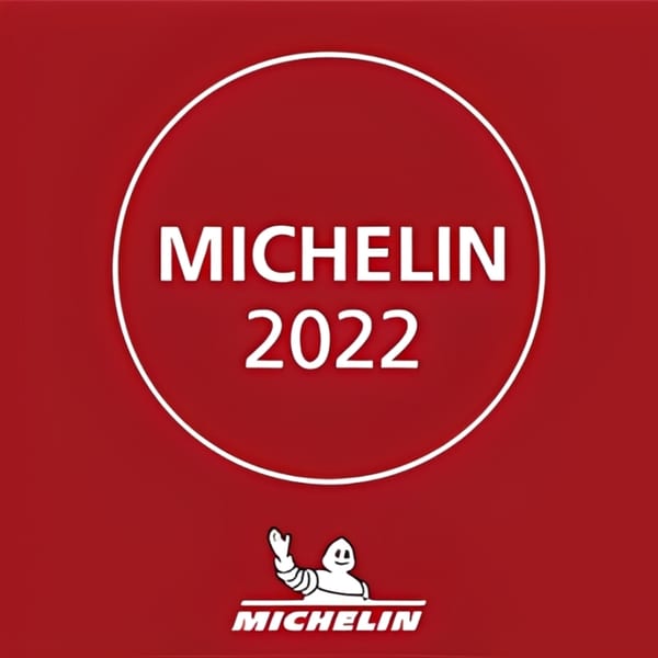 Red background with a white circle containing "MICHELIN 2022" and the Michelin Man logo.