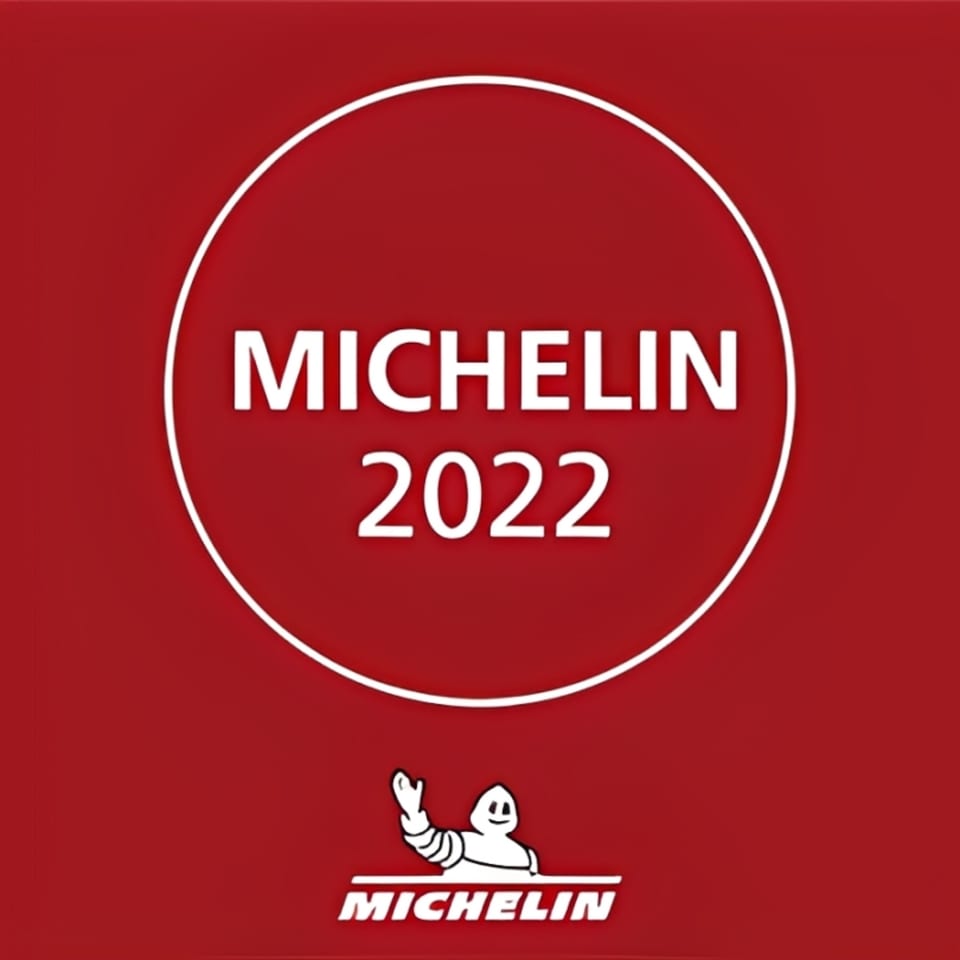 Red background with a white circle containing "MICHELIN 2022" and the Michelin Man logo.